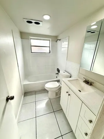 a bathroom with a double vanity sink and mirror