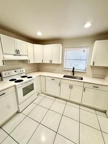 a white kitchen with cabinets and appliances