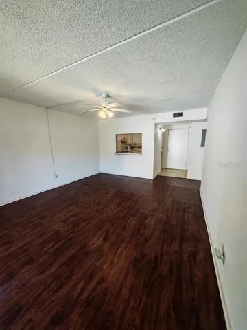 a view of an empty room and wooden floor