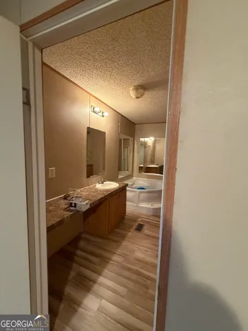 a bathroom with a double vanity sink and mirror