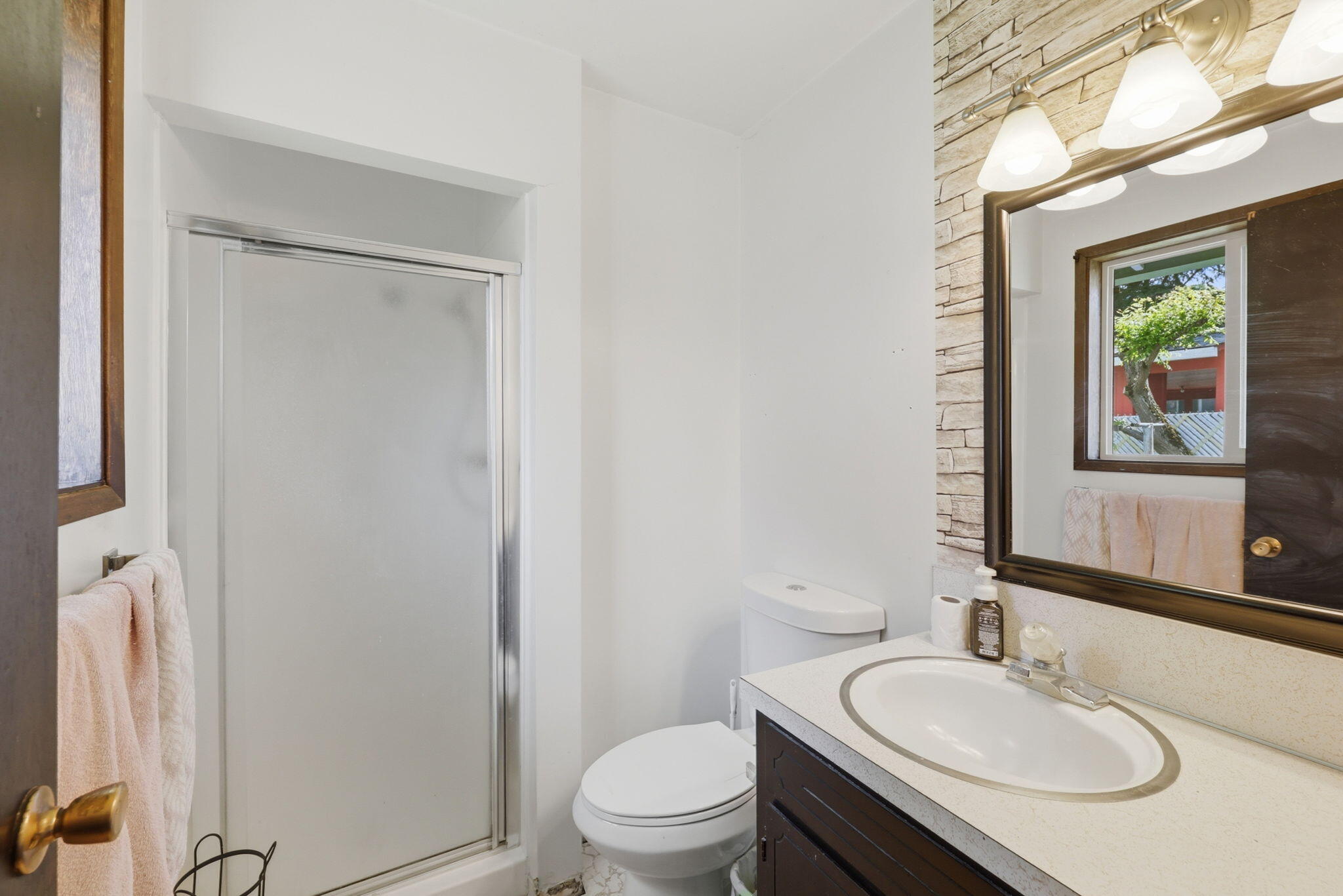 102 Elm Street Phoenix, OR 97535 - Photo 23 of 28 a bathroom with a granite countertop sink toilet a mirror and a tub