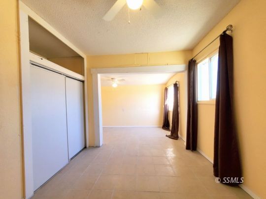 801 West Moyer Avenue Ridgecrest, CA 93555 - Photo 15 of 23 a view of a hallway with wooden shelves