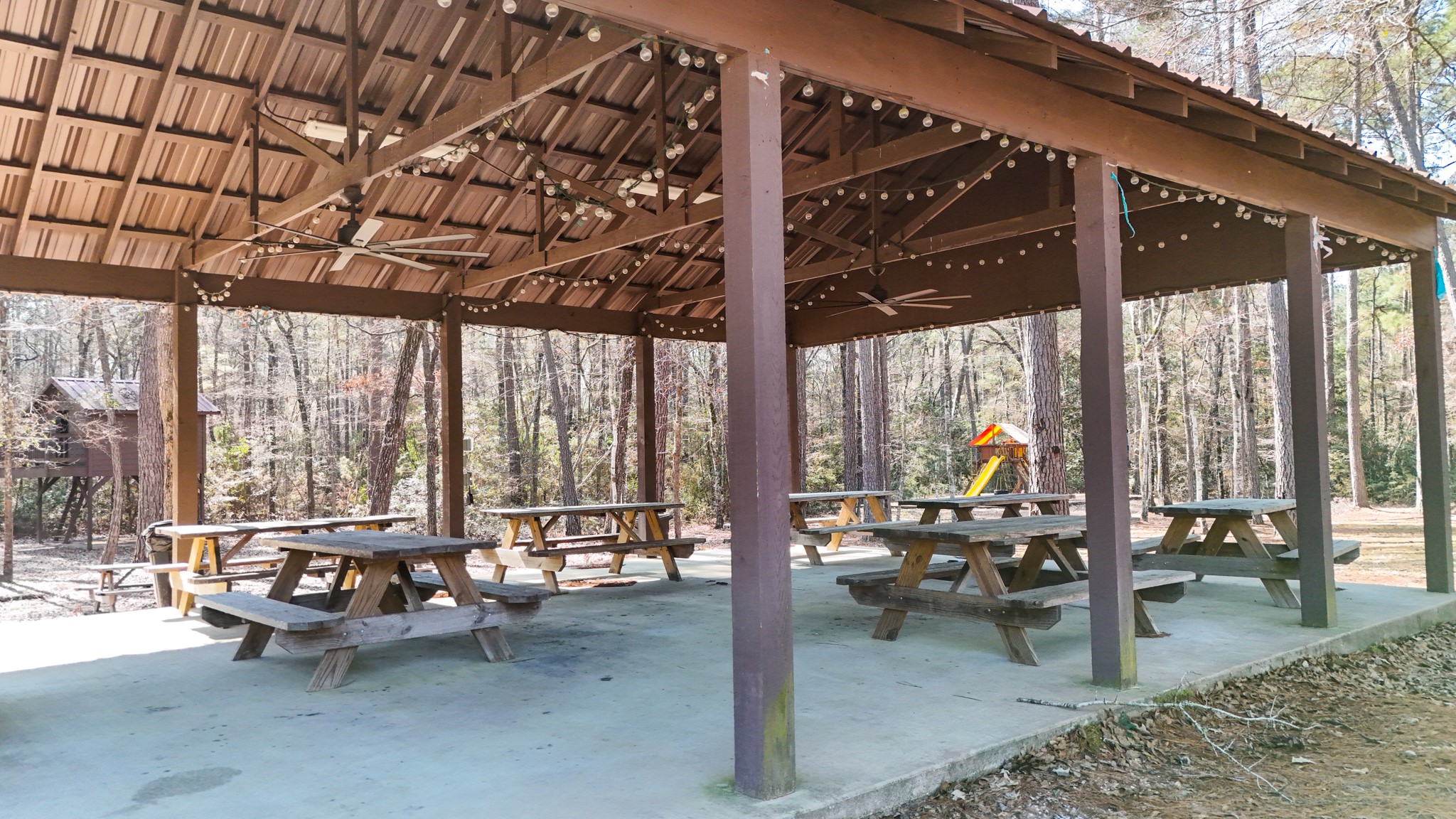 5-23-14 Rim Rock Road Huntsville, TX 77340 - Photo 37 of 45 Whether you’re relaxing or hosting friends, this scenic picnic pavilion provides a peaceful spot to unwind in the heart of nature.