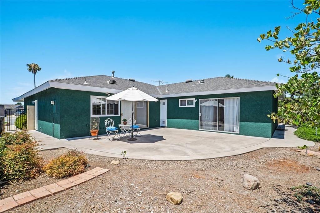 2233 East Everett Place Orange, CA 92867 - Photo 2 of 40 a patio with a table and chairs under an umbrella
