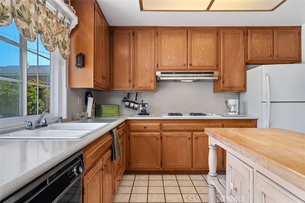 2233 East Everett Place Orange, CA 92867 - Photo 21 of 40 a kitchen with a sink stove and cabinets