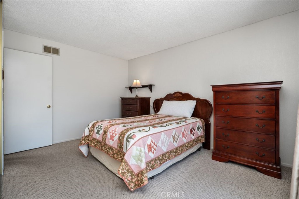 2233 East Everett Place Orange, CA 92867 - Photo 25 of 40 a bedroom with a bed and a dresser