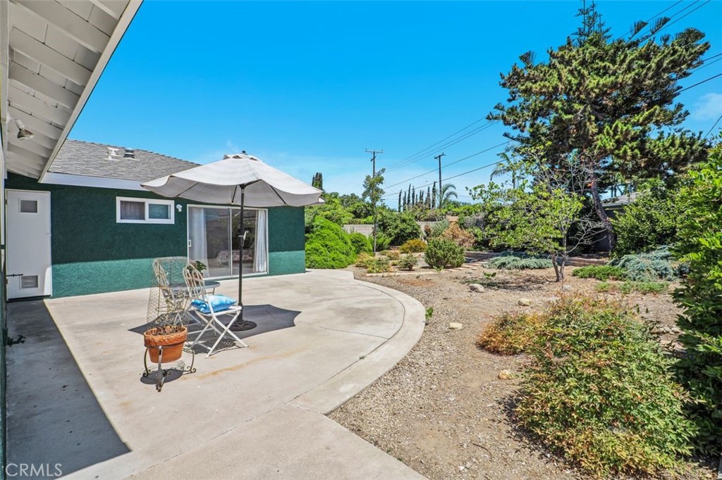 2233 East Everett Place Orange, CA 92867 - Photo 31 of 40 a view of a patio with a table and chairs under an umbrella
