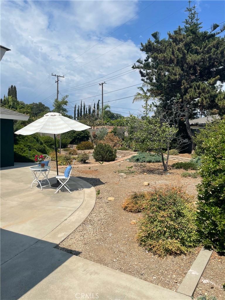 2233 East Everett Place Orange, CA 92867 - Photo 33 of 40 a table and chairs under an umbrella