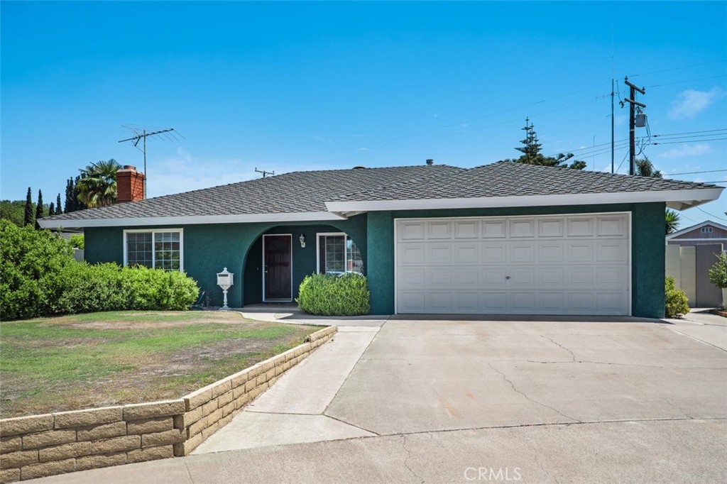 2233 East Everett Place Orange, CA 92867 - Photo 39 of 40 a front view of a house with a yard and potted plants