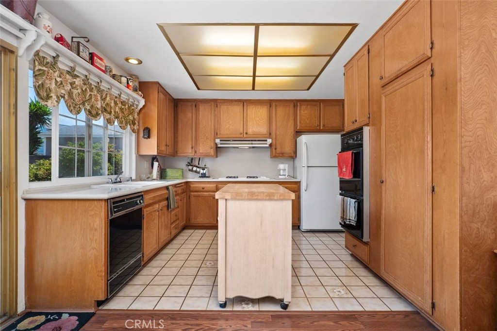 2233 East Everett Place Orange, CA 92867 - Photo 4 of 40 a kitchen with a stove a sink and a refrigerator