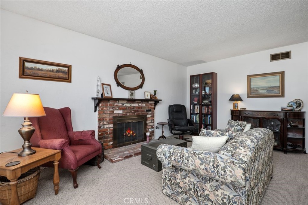 2233 East Everett Place Orange, CA 92867 - Photo 8 of 40 a living room with furniture a fireplace and window