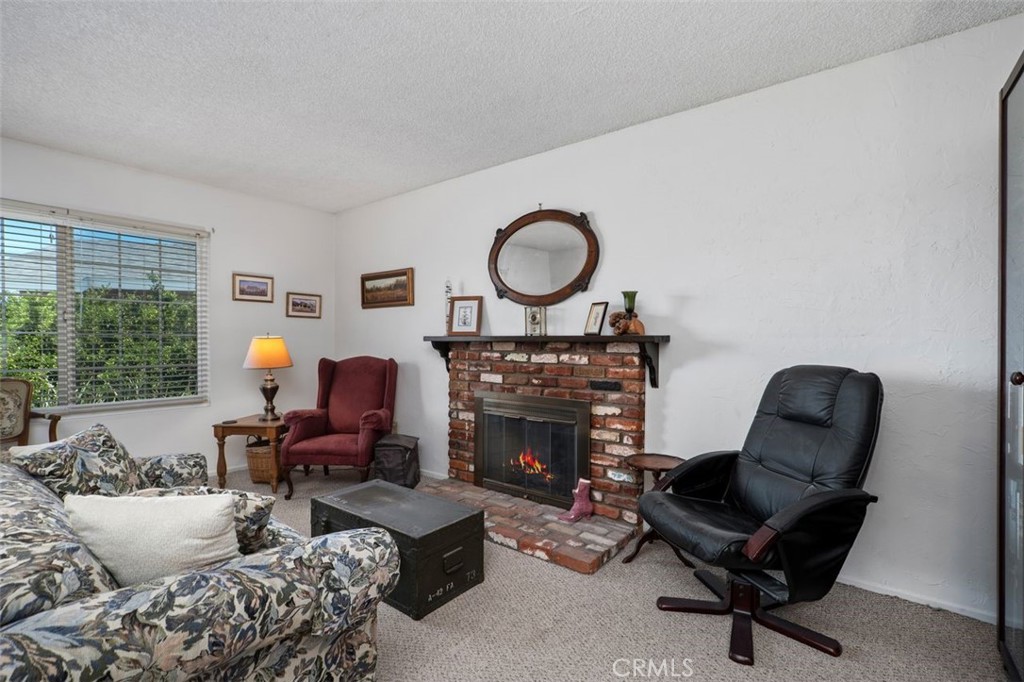 2233 East Everett Place Orange, CA 92867 - Photo 10 of 40 a living room with furniture and a fireplace