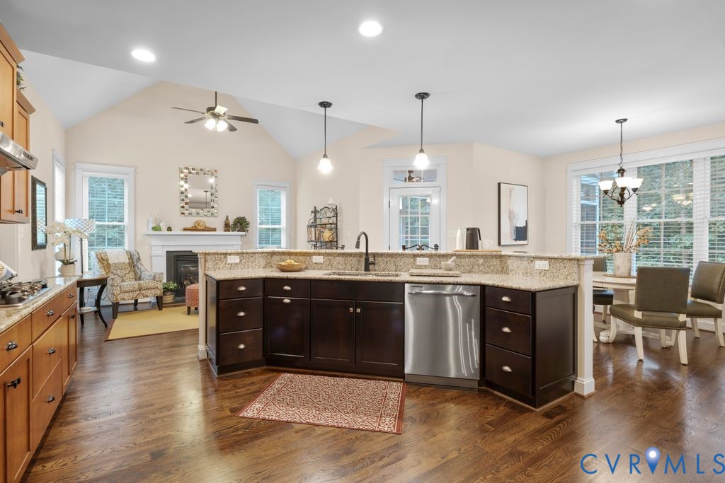 11518 Barrows Ridge Lane Chesterfield, VA 23838 - Photo 11 of 41 a large kitchen with kitchen island granite countertop a large center island a stove and a wooden floors