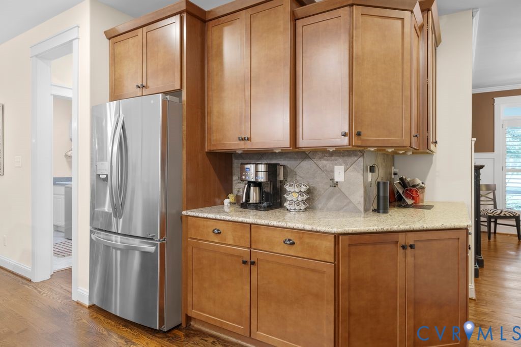 11518 Barrows Ridge Lane Chesterfield, VA 23838 - Photo 13 of 41 a kitchen with stainless steel appliances granite countertop a refrigerator a sink and white cabinets with wooden floor