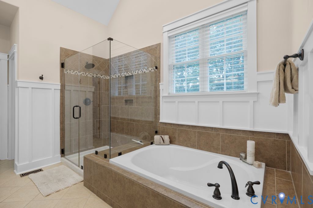 11518 Barrows Ridge Lane Chesterfield, VA 23838 - Photo 19 of 41 a bathroom with a tub a sink and a window