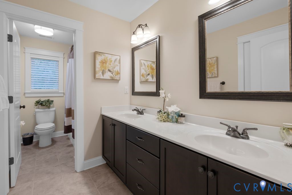 11518 Barrows Ridge Lane Chesterfield, VA 23838 - Photo 28 of 41 a bathroom with a double vanity sink toilet and a mirror