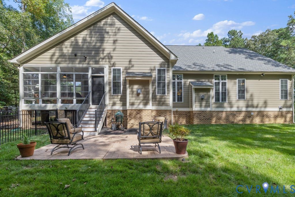 11518 Barrows Ridge Lane Chesterfield, VA 23838 - Photo 35 of 41 a front view of a house with a yard table and chairs