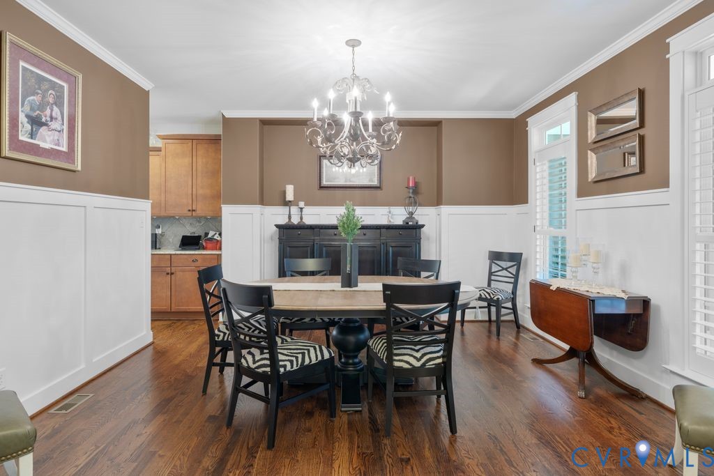 11518 Barrows Ridge Lane Chesterfield, VA 23838 - Photo 6 of 41 a view of a dining room with furniture a chandelier and wooden floor