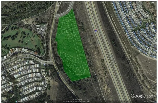 a view of a yard with wooden fence