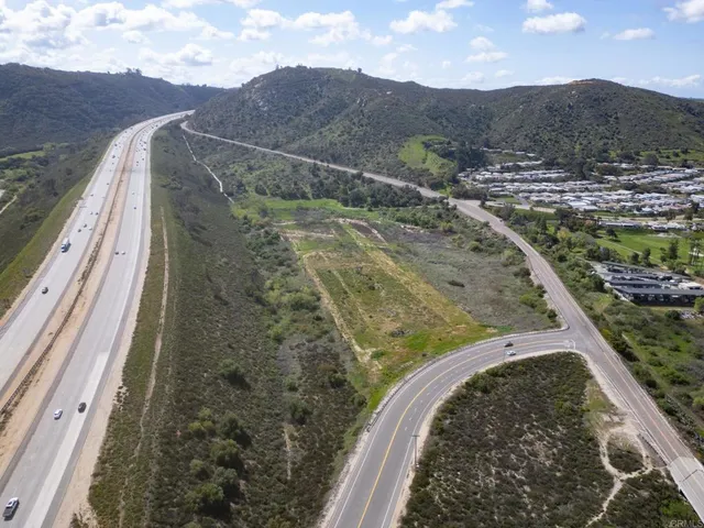 a view of a yard with wooden fence