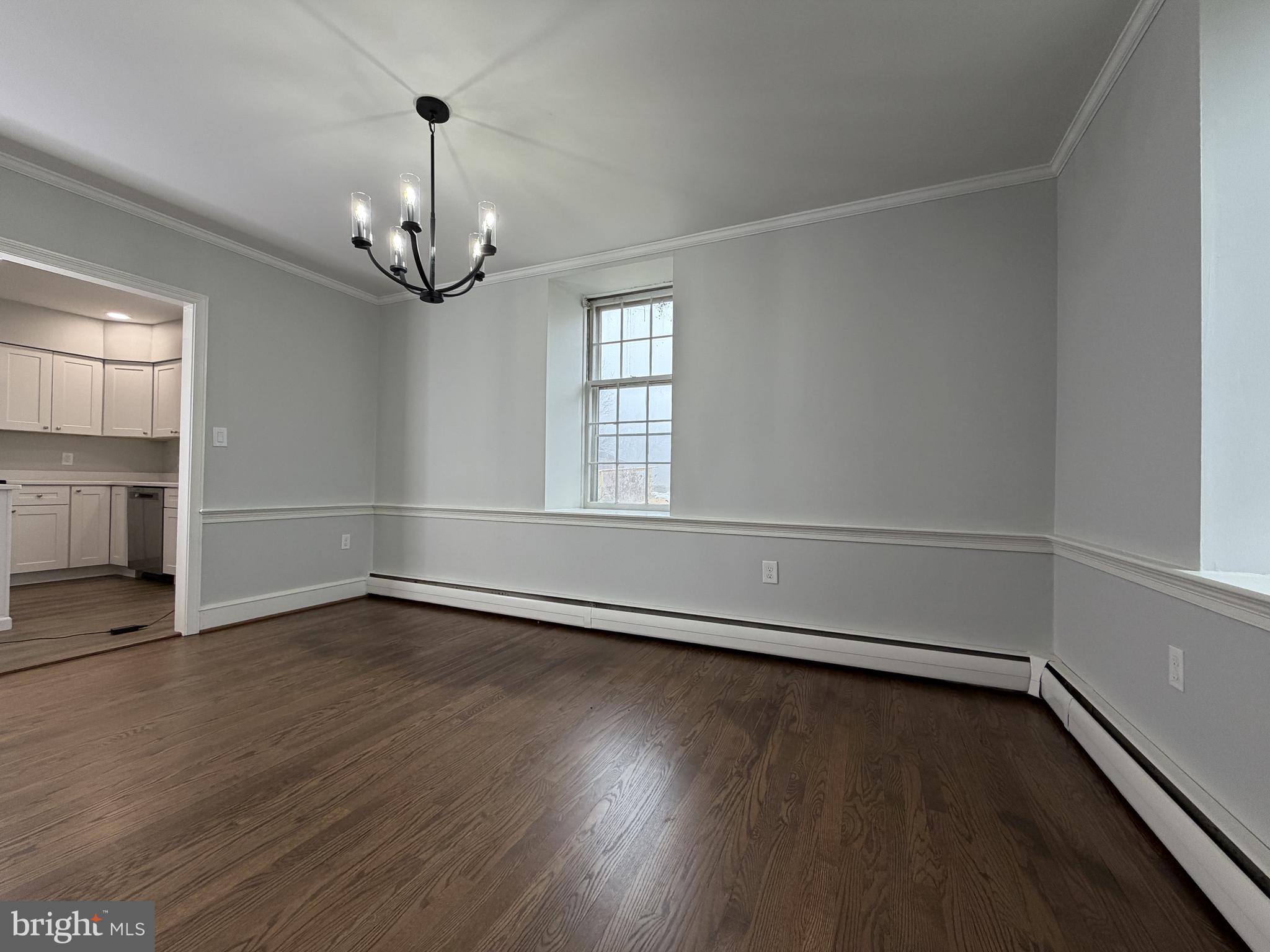 4700 Thompsons Bridge Road Wilmington, DE 19803 - Photo 17 of 41 an empty room with wooden floor chandelier and windows
