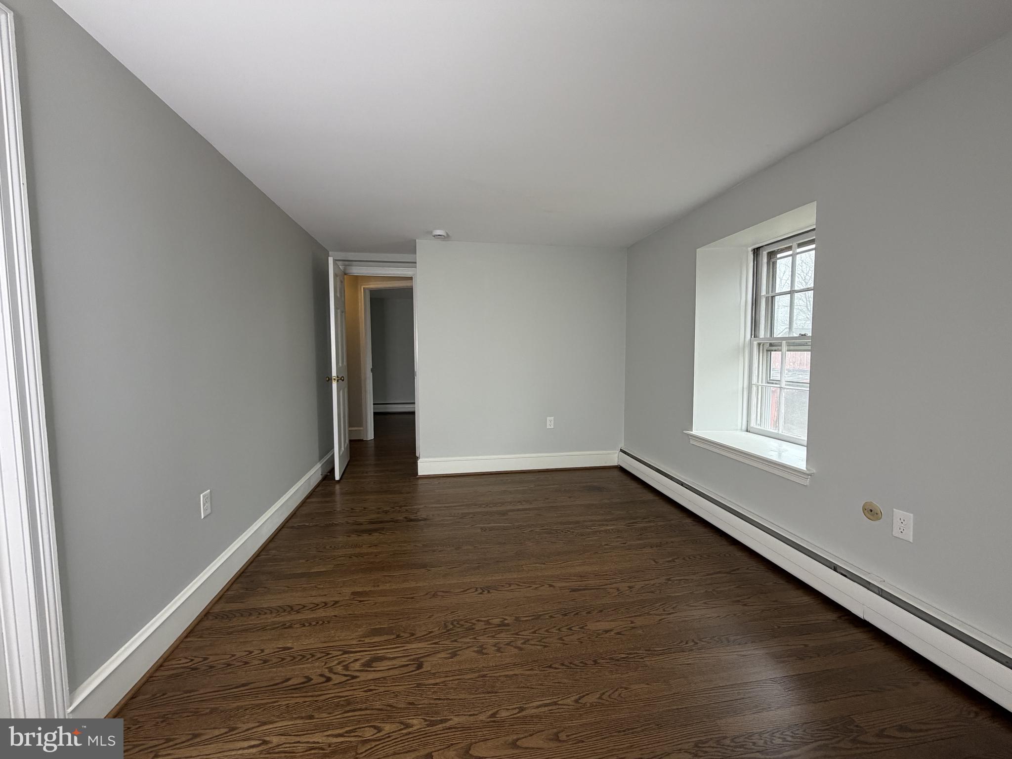 4700 Thompsons Bridge Road Wilmington, DE 19803 - Photo 33 of 41 a view of an empty room with wooden floor and a window