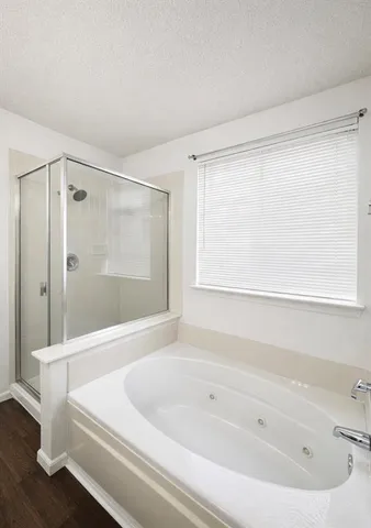 a bedroom with a bed and lamp