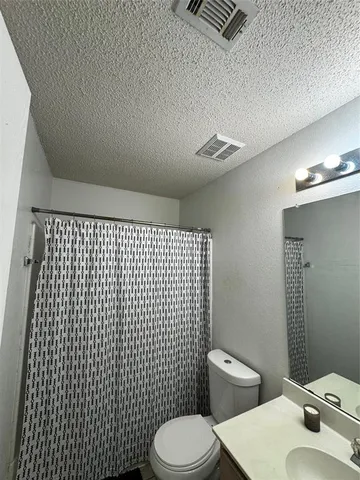 a bedroom with a bed and cabinets