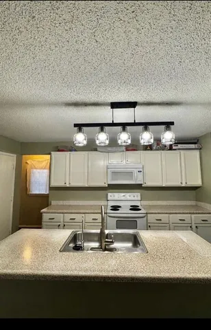 a view of kitchen with kitchen island and wooden floor