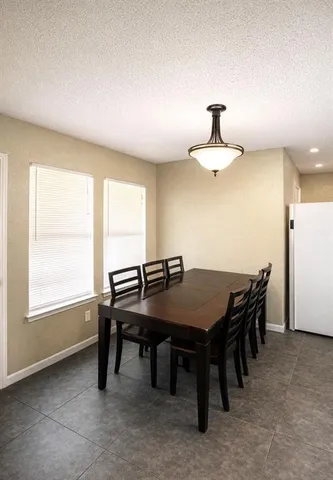 a view of a dining room with furniture and window
