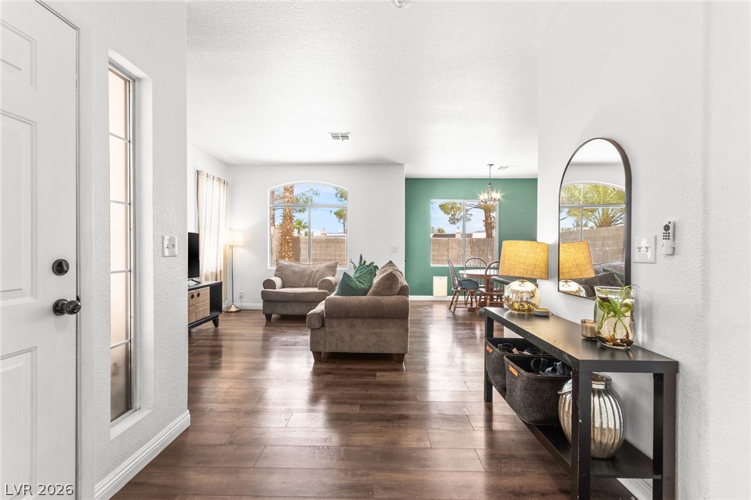7353 Ridge Star Court Las Vegas, NV 89131 - Photo 2 of 36 Rich hardwood flooring extends through this open-concept living area with abundant natural light.
