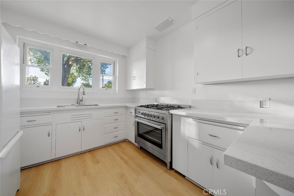 4693 Central Riverside, CA 92506 - Photo 12 of 31 a kitchen with granite countertop white cabinets and white stainless steel appliances