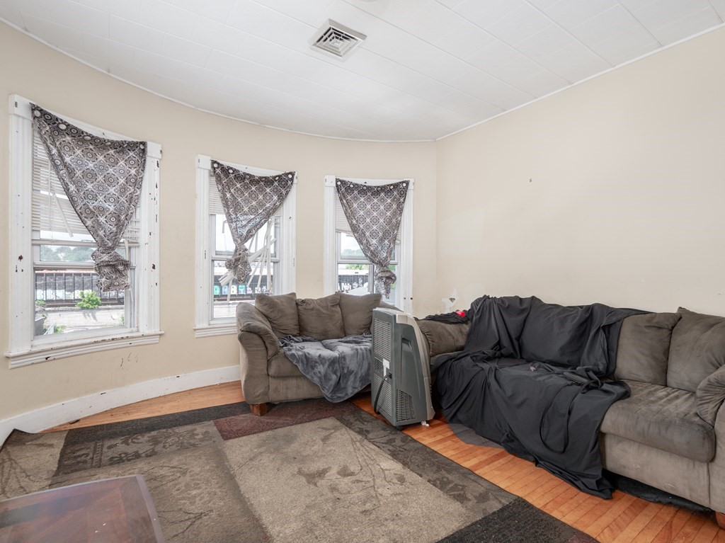 83 Canterbury Street Worcester, MA 01603 - Photo 18 of 42 a living room with furniture and a window