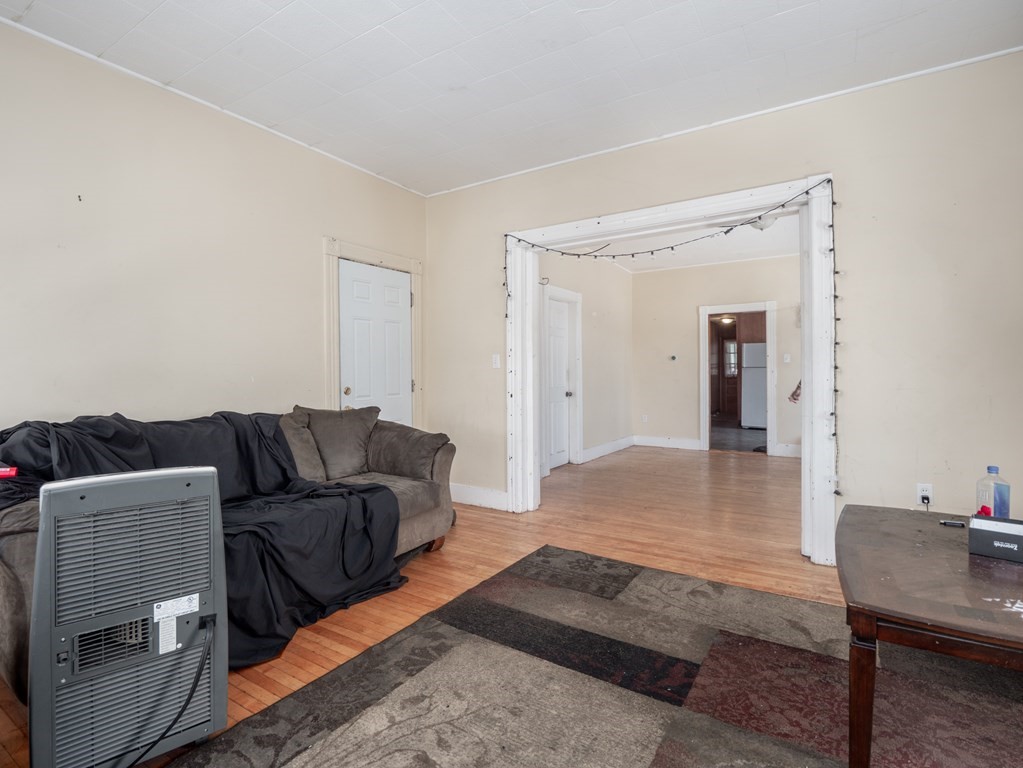 83 Canterbury Street Worcester, MA 01603 - Photo 19 of 42 a living room with furniture and a wooden floor
