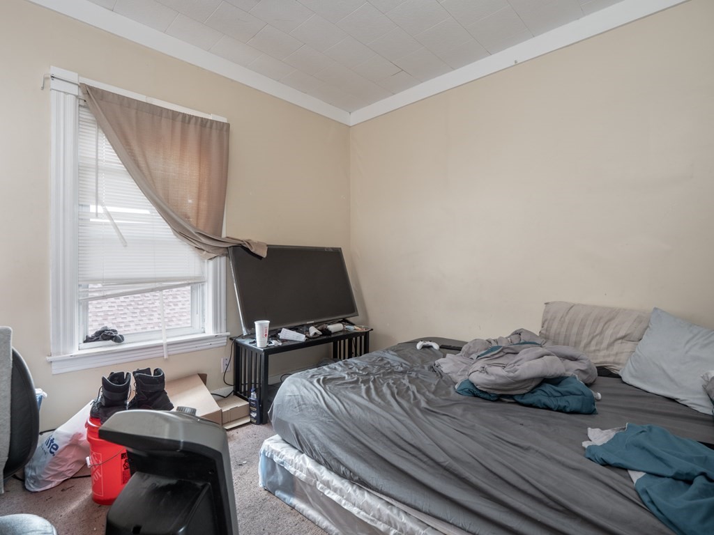 83 Canterbury Street Worcester, MA 01603 - Photo 23 of 42 a bedroom with a bed and a window