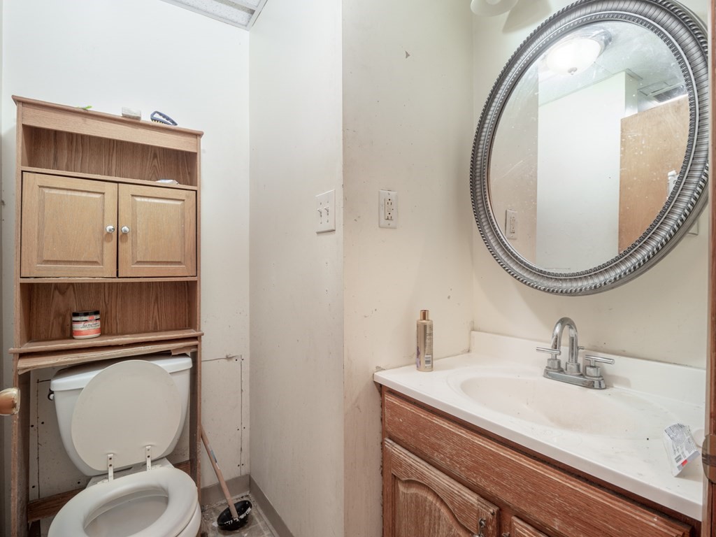 83 Canterbury Street Worcester, MA 01603 - Photo 26 of 42 a bathroom with a toilet sink and mirror
