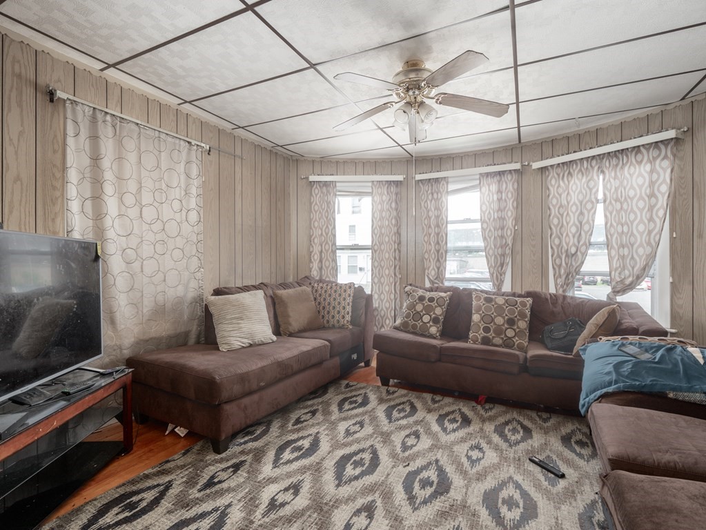 83 Canterbury Street Worcester, MA 01603 - Photo 3 of 42 a living room with furniture and a flat screen tv