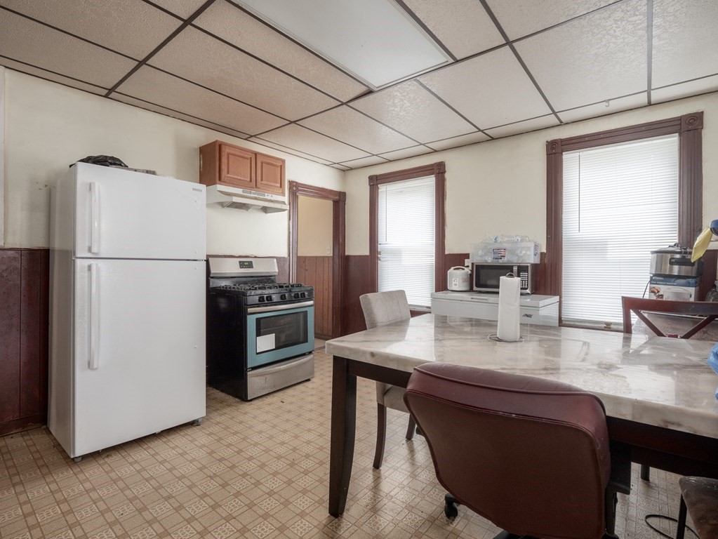 83 Canterbury Street Worcester, MA 01603 - Photo 6 of 42 a kitchen with stainless steel appliances white cabinets and wooden floor