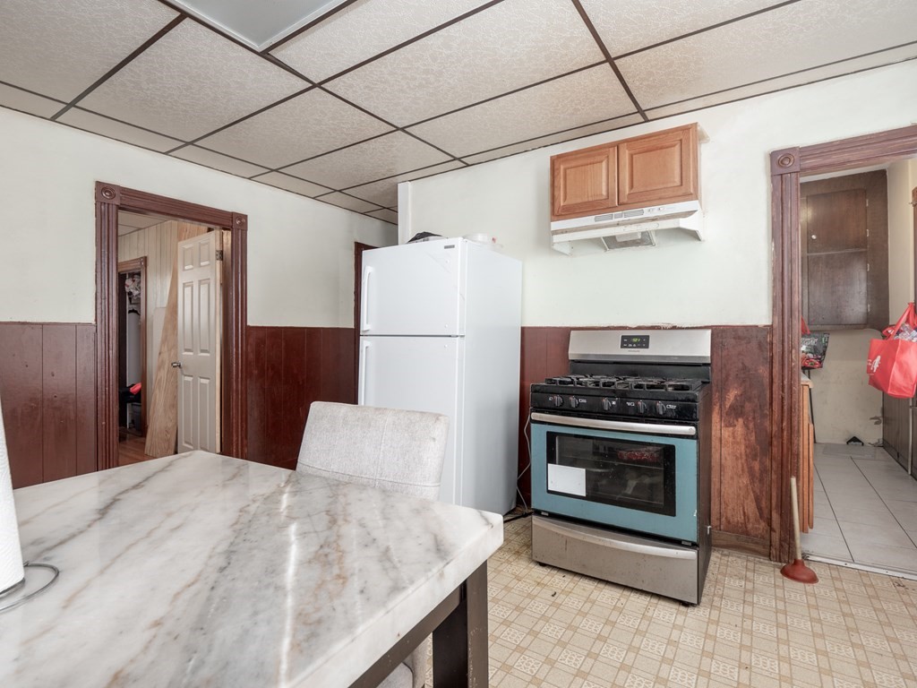 83 Canterbury Street Worcester, MA 01603 - Photo 7 of 42 a kitchen with stainless steel appliances kitchen island a stove a refrigerator and a cabinets