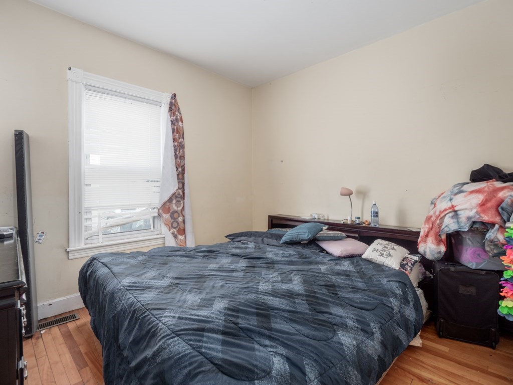 83 Canterbury Street Worcester, MA 01603 - Photo 8 of 42 a bedroom with a bed and a window