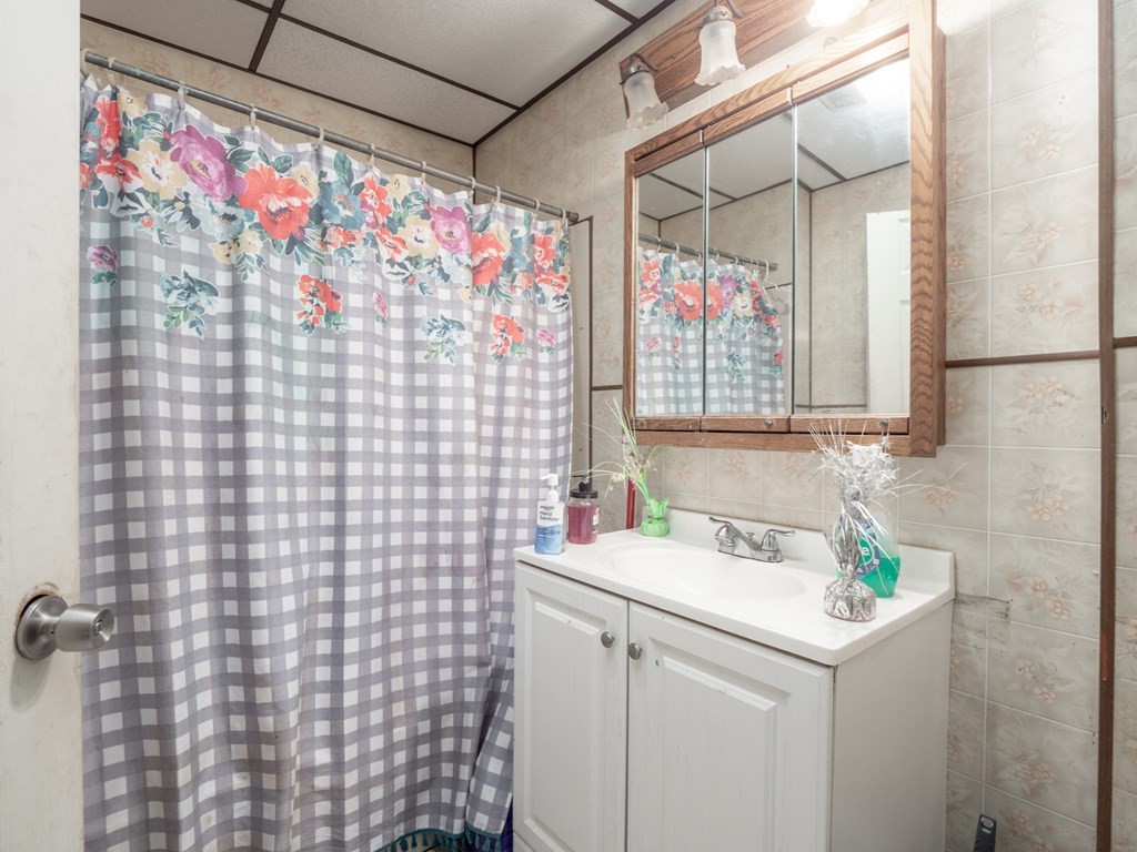 83 Canterbury Street Worcester, MA 01603 - Photo 9 of 42 a bathroom with a sink a vanity and a shower