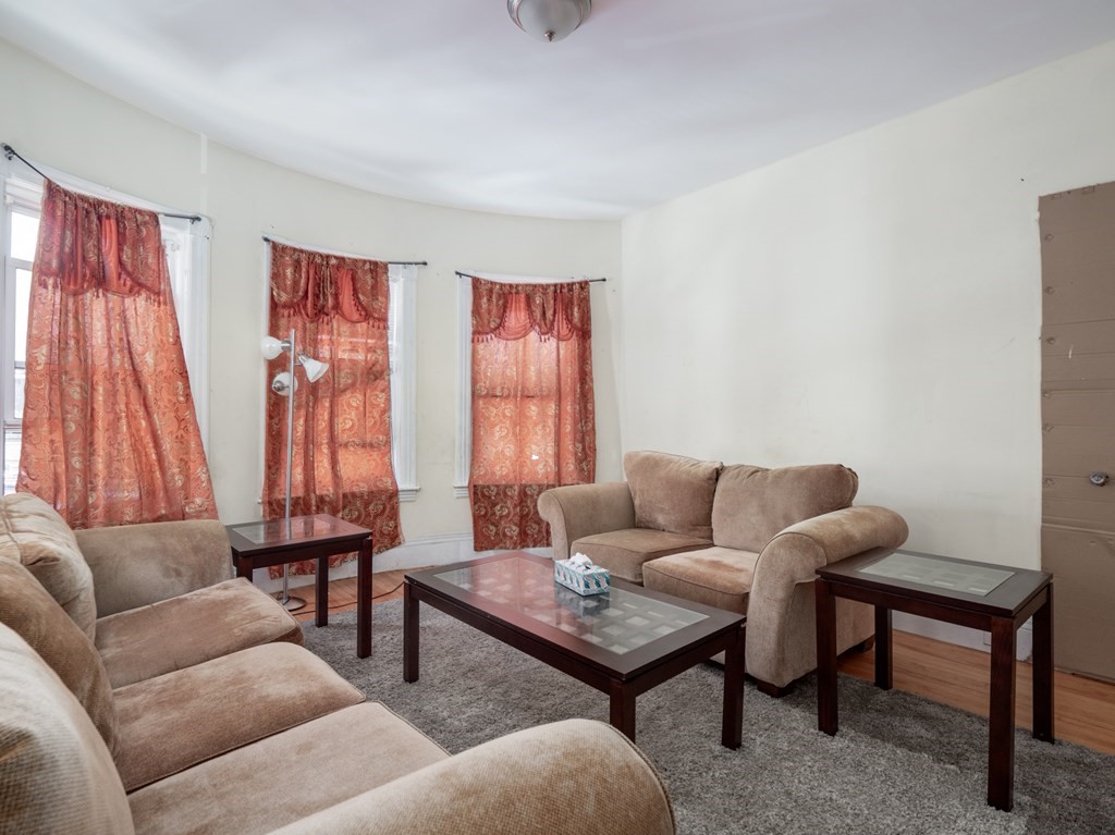 83 Canterbury Street Worcester, MA 01603 - Photo 10 of 42 a living room with furniture and a window