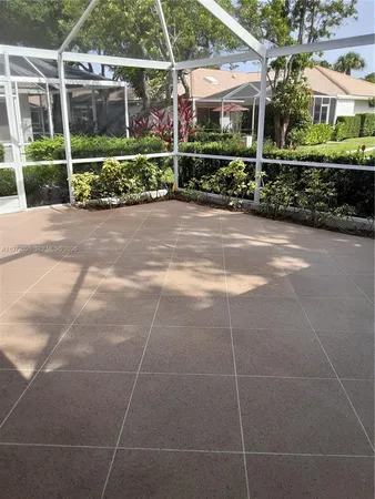 a view of a chair and table in backyard of house