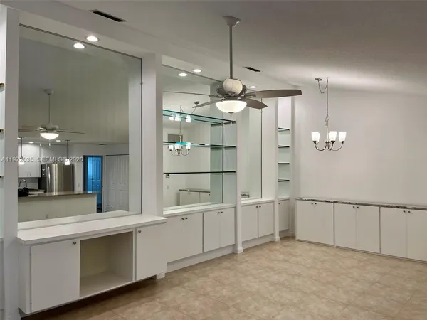 a view of a kitchen with a sink and chandelier