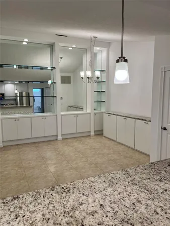 a view of a kitchen with a sink and cabinets