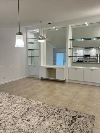 a view of a kitchen with a sink and cabinets