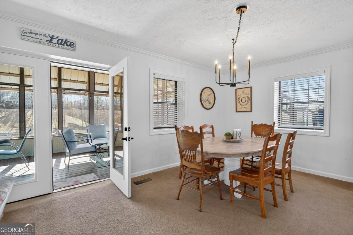 219 Hickory Pass Sparta, GA 31087 - Photo 13 of 62 a view of a dining room with furniture and a table