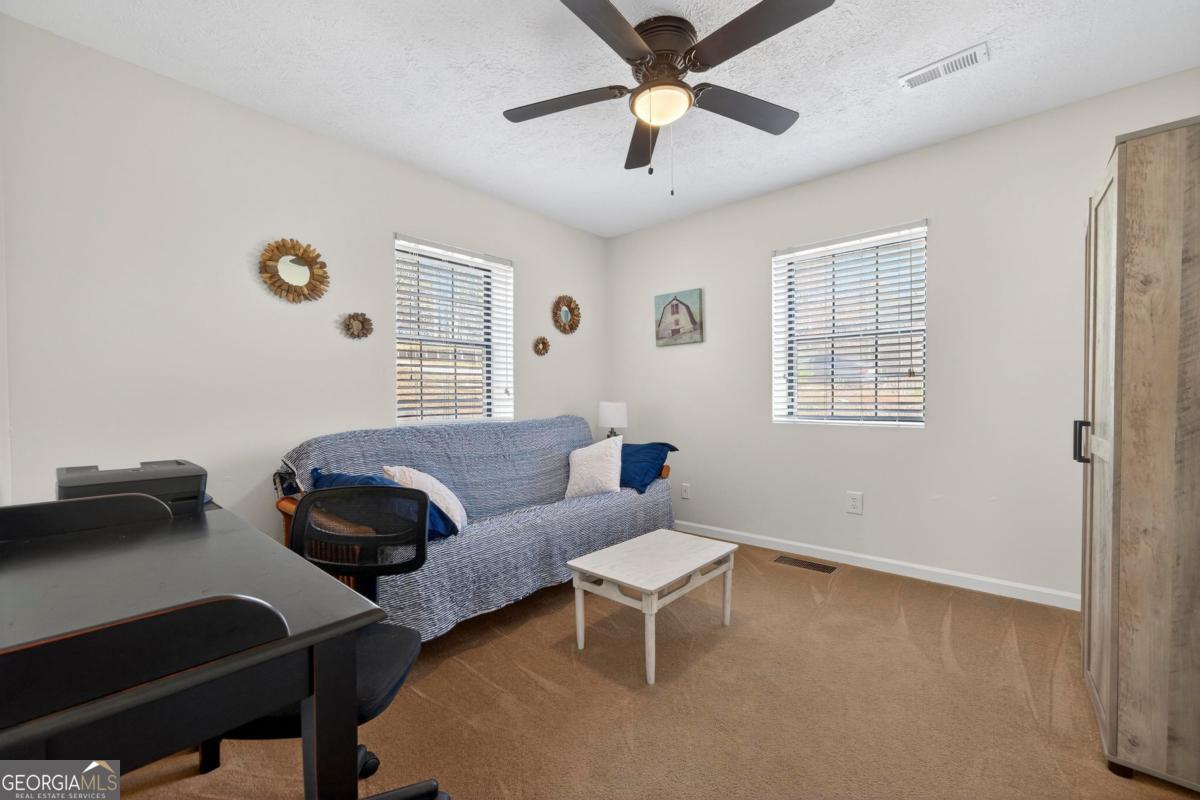 219 Hickory Pass Sparta, GA 31087 - Photo 16 of 62 a living room with furniture and a window