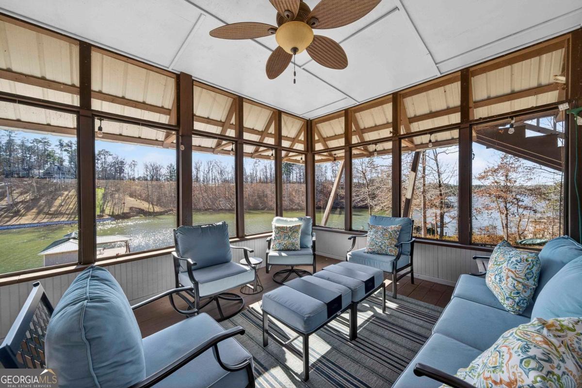 219 Hickory Pass Sparta, GA 31087 - Photo 20 of 62 a living room with furniture and floor to ceiling windows
