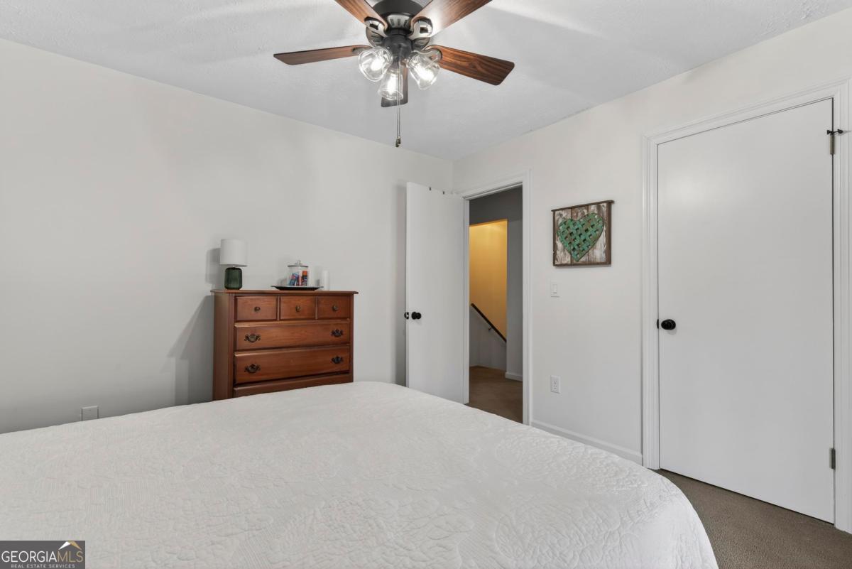 219 Hickory Pass Sparta, GA 31087 - Photo 26 of 62 a bedroom with a bed and a chandelier